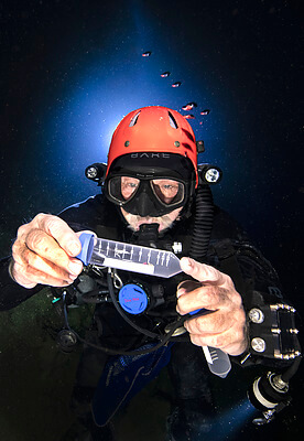 Dr. Thomas Illiffe collects a blind cave shrimp that could be a new species inside of Giant Cave Belize. The process is very unique and he's perfected it in an extreme environment. His work could show how organisms can survive in hash environments on other planets. Credit: Becky Schott